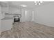 Modern kitchen with stainless appliances and gray flooring, adjacent to the dining space at 37 Weeping Willow Ln, Lillington, NC 27546