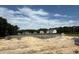 New home construction showing cinder block foundation in a neighborhood surrounded by trees under a blue sky at 380 Shelby Meadow Ln, Angier, NC 27501