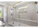 Luxurious bathroom featuring a large glass shower with marble tile and gold fixtures at 3934 Old Chapel Hill Rd, Durham, NC 27707
