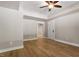 Spacious bedroom featuring hardwood floors, a ceiling fan, and neutral paint at 3934 Old Chapel Hill Rd, Durham, NC 27707