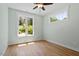 Bright bedroom featuring wood floors, two windows, and a ceiling fan at 3934 Old Chapel Hill Rd, Durham, NC 27707