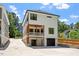 Rear exterior view of a two-story home with a large driveway, garage, and inviting balcony at 3934 Old Chapel Hill Rd, Durham, NC 27707