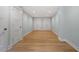 Hallway featuring laminate flooring, neutral paint, and ample closet space at 3934 Old Chapel Hill Rd, Durham, NC 27707