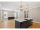 Open kitchen with island, white countertops, and gold light fixtures at 3934 Old Chapel Hill Rd, Durham, NC 27707