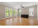 Bright and airy living room featuring hardwood floors, ceiling fan, and doors to an outdoor deck at 3934 Old Chapel Hill Rd, Durham, NC 27707