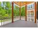 Spacious outdoor porch with wood ceiling, offering views of the surrounding greenery and neighborhood at 3934 Old Chapel Hill Rd, Durham, NC 27707