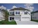 Charming two-story home featuring a two-car garage and welcoming front porch at 40 New Liberty Dr, Youngsville, NC 27596