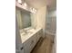 This modern bathroom features dual sinks, a large mirror and updated countertops and fixtures at 408 La Maison Ave # 3, Wendell, NC 27591
