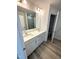 Bathroom with a double sink vanity, large mirror and walk-in shower at 408 La Maison Ave # 3, Wendell, NC 27591