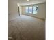 This spacious carpeted bedroom features large windows offering natural light at 408 La Maison Ave # 3, Wendell, NC 27591