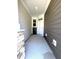 The front porch offers neutral colors, overhead lighting and room for furniture at 408 La Maison Ave # 3, Wendell, NC 27591