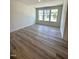 This spacious living room features luxury vinyl plank flooring and large windows offering natural light at 408 La Maison Ave # 3, Wendell, NC 27591
