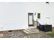 View of back entrance with door, stairs, and exterior air conditioning unit at 409 Glaive Dr, Durham, NC 27703
