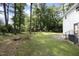 Spacious backyard featuring a lush lawn and mature trees, perfect for outdoor enjoyment and relaxation at 409 Glaive Dr, Durham, NC 27703