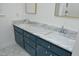 Bathroom features double sink with marble countertop and a blue vanity at 409 Glaive Dr, Durham, NC 27703