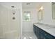 Bright bathroom with tub/shower combo and double sinks with marble counters at 409 Glaive Dr, Durham, NC 27703