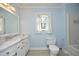 Powder blue bathroom with tiled floors, marble countertop, and modern toilet at 409 Glaive Dr, Durham, NC 27703