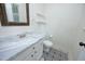 A modern bathroom with ornate floor tiling, a sink and toilet at 409 Glaive Dr, Durham, NC 27703