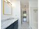Bathroom with hexagon tile floors, marble countertop, and gold trimmed mirror at 409 Glaive Dr, Durham, NC 27703