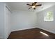 Bedroom featuring wood-look flooring, large window, and big closet at 409 Glaive Dr, Durham, NC 27703