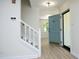 Entryway featuring a staircase and blue front door, leading to a bright living area at 409 Glaive Dr, Durham, NC 27703
