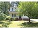 Charming two-story home with a welcoming front porch and mature tree at 409 Glaive Dr, Durham, NC 27703