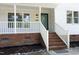 Welcoming front porch with brick base and white railing, leading to the home's entrance at 409 Glaive Dr, Durham, NC 27703