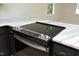 The kitchen island features an electric range, stainless hardware and marble countertops at 409 Glaive Dr, Durham, NC 27703