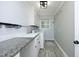Bright laundry room with modern appliances and light-colored cabinets at 409 Glaive Dr, Durham, NC 27703