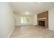 Inviting living room with a brick fireplace, large windows, and light wood floors at 409 Glaive Dr, Durham, NC 27703