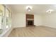 Bright living room with a brick fireplace, large windows, and light wood floors at 409 Glaive Dr, Durham, NC 27703