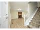 Spacious living room featuring a brick fireplace and staircase to the upper floor at 409 Glaive Dr, Durham, NC 27703