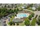 Aerial view of a community swimming pool and playground with surrounding homes and trees at 417 Austin View Blvd, Wake Forest, NC 27587