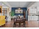 Dining area with a unique lighting fixture, wood table, and stylish decor accents at 417 Austin View Blvd, Wake Forest, NC 27587