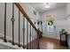Welcoming foyer featuring hardwood floors, decorative railing, and natural light at 417 Austin View Blvd, Wake Forest, NC 27587