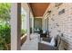 Inviting front porch with seating area, brick accents, and outdoor lighting at 417 Austin View Blvd, Wake Forest, NC 27587