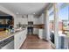 Bright kitchen with white cabinets, stainless steel appliances, granite countertops, and sliding glass doors at 417 Austin View Blvd, Wake Forest, NC 27587