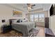 Comfortable bedroom with a tray ceiling, ceiling fan, large bed, and natural light at 417 Austin View Blvd, Wake Forest, NC 27587