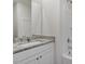 Bathroom vanity showcasing granite countertop, white cabinets, mirror, and a view of the bath/shower at 418 Ivy Bank Dr, Angier, NC 27501