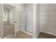 The bathroom has a glass-enclosed shower and shelving in the closet, next to the carpeted bedroom at 418 Ivy Bank Dr, Angier, NC 27501