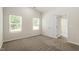 A cozy bedroom featuring plush carpet, neutral walls, and abundant natural light from two windows at 418 Ivy Bank Dr, Angier, NC 27501