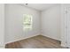 Bright bedroom with hardwood floors, a window with natural light, and a closet door at 418 Ivy Bank Dr, Angier, NC 27501