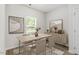 Light-filled dining room featuring modern decor, wood floors, and a large window at 418 Ivy Bank Dr, Angier, NC 27501