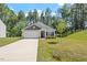 Inviting single-story home featuring a spacious driveway, attached garage, and lush green lawn at 418 Ivy Bank Dr, Angier, NC 27501