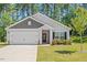 Charming single-story home with a well-manicured lawn, attached garage, and a welcoming front entrance at 418 Ivy Bank Dr, Angier, NC 27501