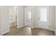 Bright hallway showcasing wood-look flooring with doors leading to a bathroom and additional rooms at 418 Ivy Bank Dr, Angier, NC 27501