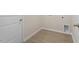 Clean laundry room featuring wood-look floors, a door, and plumbing fixtures for a washer and dryer at 418 Ivy Bank Dr, Angier, NC 27501