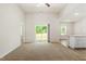 Open-concept living area with neutral carpet, a sliding glass door and a view to the backyard at 418 Ivy Bank Dr, Angier, NC 27501