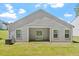 Back of home with siding and sliding glass doors to the outside patio and grassy backyard at 418 Ivy Bank Dr, Angier, NC 27501