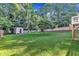 Expansive backyard offers lush greenery, a storage shed, and secure fencing, combining utility and privacy at 4309 Birmingham Way, Raleigh, NC 27604